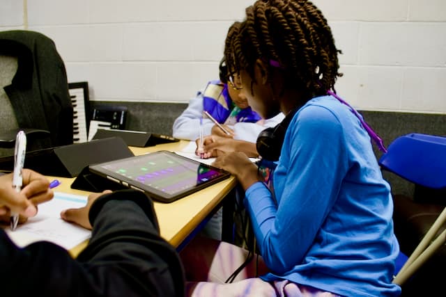 Two students working on music production at the Production Lab, Kynda Learning